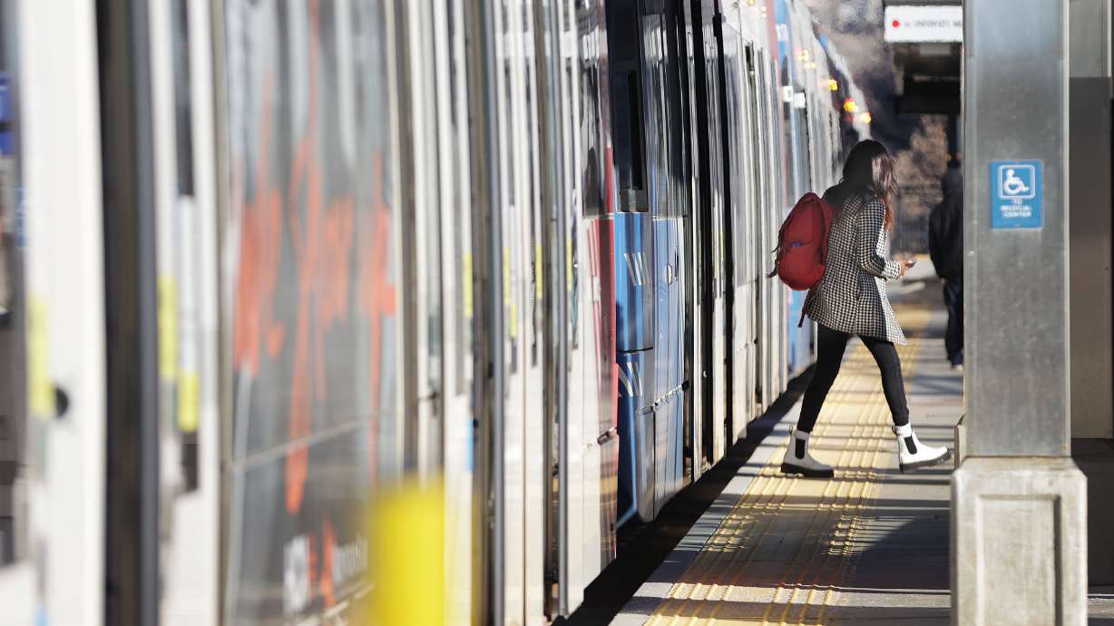 A TRAX rider exits a train in Salt Lake City on Feb. 1, 2022. Utah Transit Authority officials have narrowed their proposed "Orange Line" route to four options as they consider a massive overhaul of the light-rail service.
