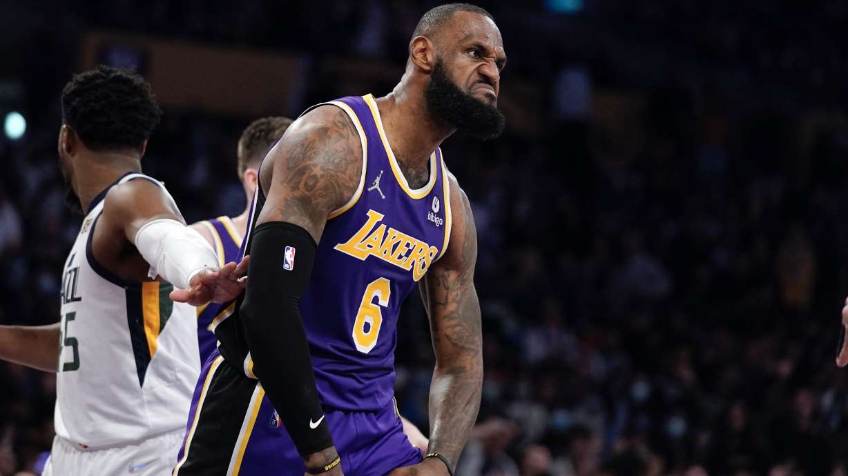 Los Angeles Lakers forward LeBron James reacts toward Aaron Donald of the Los Angeles Rams, who was sitting court side, after scoring during the second half of an NBA basketball game against the Utah Jazz Wednesday, Feb. 16, 2022, in Los Angeles. The Lakers won 106-101.