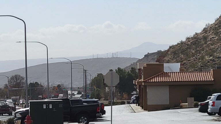 The mountains behind the radio and TV towers on Webb Hill are obscured by haze as seen from Bluff Street in St. George on Wednesday.