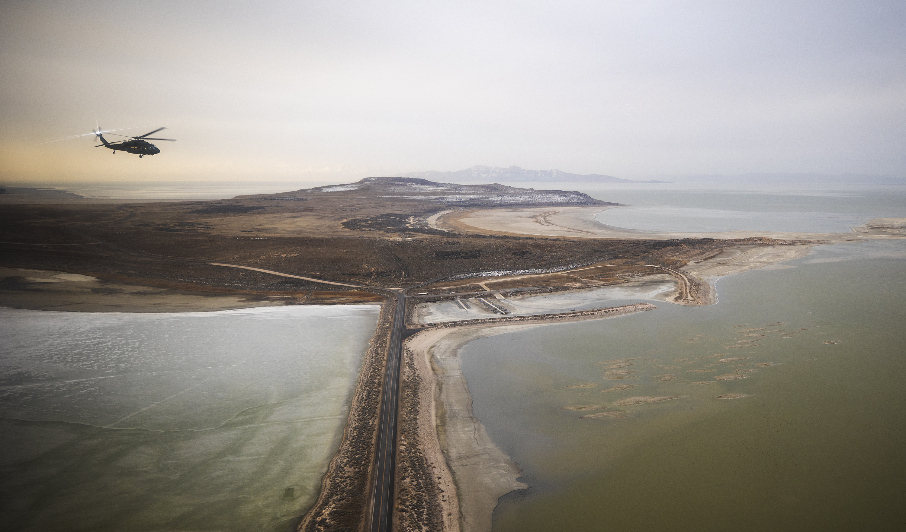 A Blackhawk helicopter flies over the Great Salt Lake as Utah lawmakers take an aerial tour with the Utah Army National Guard on Feb. 15. The U.S. Congress is close to finalizing legislation that would provide $25 million over five years toward studying the Great Salt Lake and other regional saline lakes.