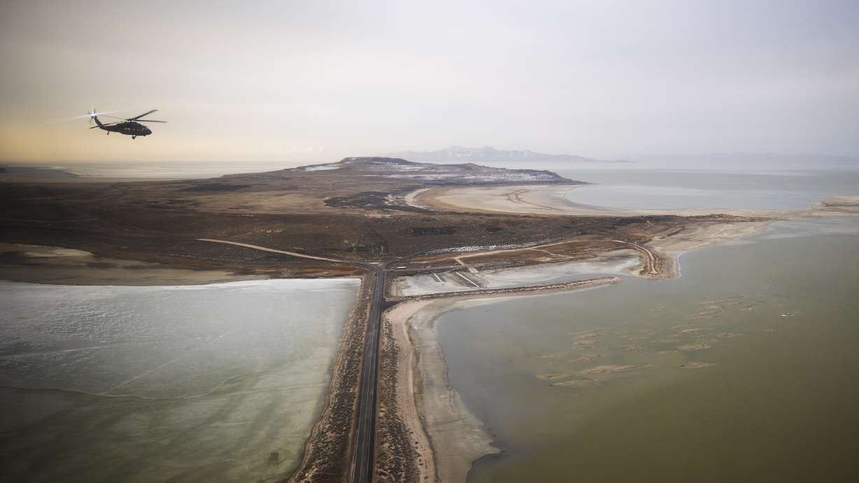 A Blackhawk helicopter flies over the Great Salt Lake as Utah lawmakers take an aerial tour of the Great Salt Lake with the Utah Army National Guard on Feb. 15. Utah Gov. Spencer Cox signed 67 bills into law Monday, including bills for the preservation of the lake.