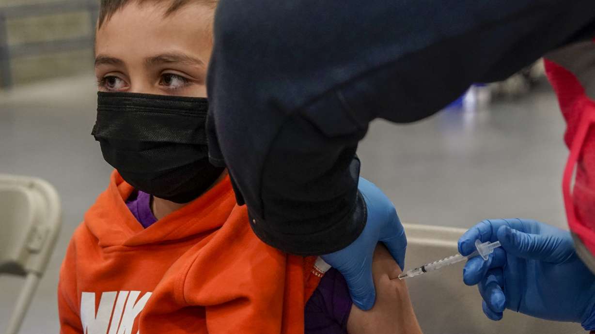 Registered nurse Clarece Glanville gives Robert Dennis-Garcia, 8, his first dose of COVID-19 vaccine at the Legacy Events Center in Farmington on Jan. 24. The Utah Department of Health and Human Services on Thursday reported 7,789 new COVID-19 cases, as well as 22 additional deaths over the past week.