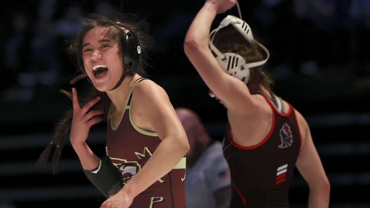 Ariana McGee of Maple Mountain celebrates her win against Chanley Green of Uintah in the 115-pound weight class during the 5A wrestling state championship at UVU in Orem on Thursday, Feb. 17, 2022.
