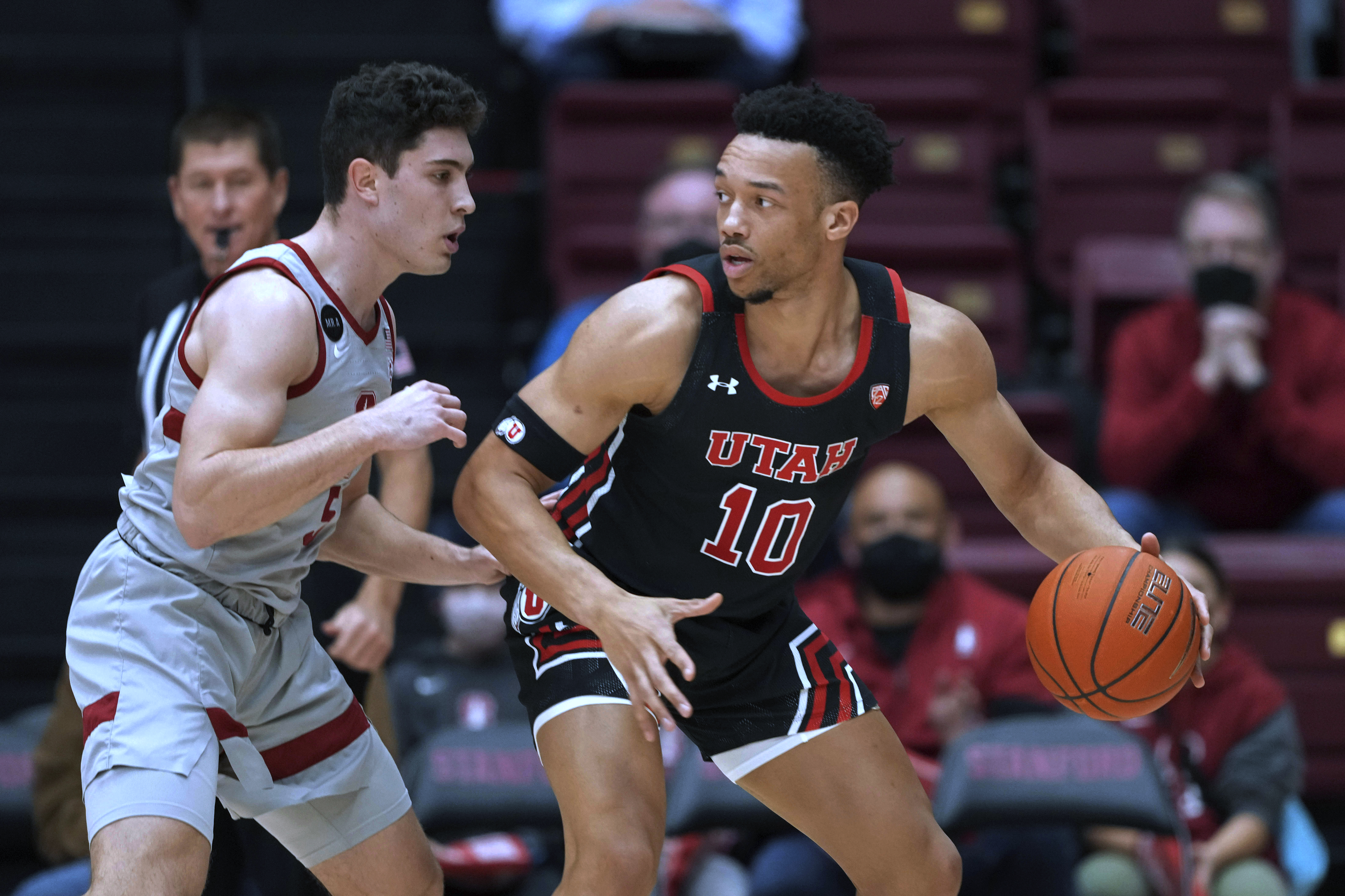 Utah guard Marco Anthony (10) is defended by Stanford guard Michael O'Connell during the first half of an NCAA college basketball game in Stanford, Calif., Thursday, Feb. 17, 2022.