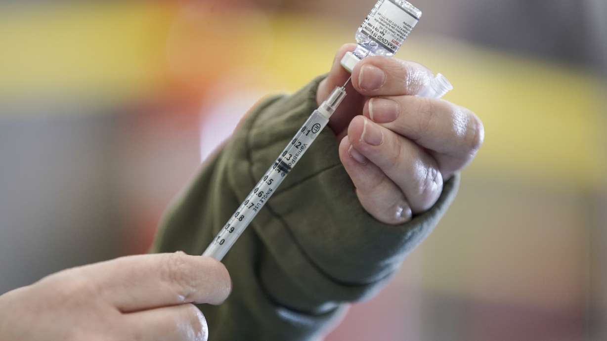 Registered nurse Erin Olpin draws a COVID-19 vaccination dose at a drive-thru clinic at the Legacy Events Center in Farmington on Jan. 24. The Utah Department of Health announced 183 new COVID-19 cases, as well as three additional deaths on Wednesday.