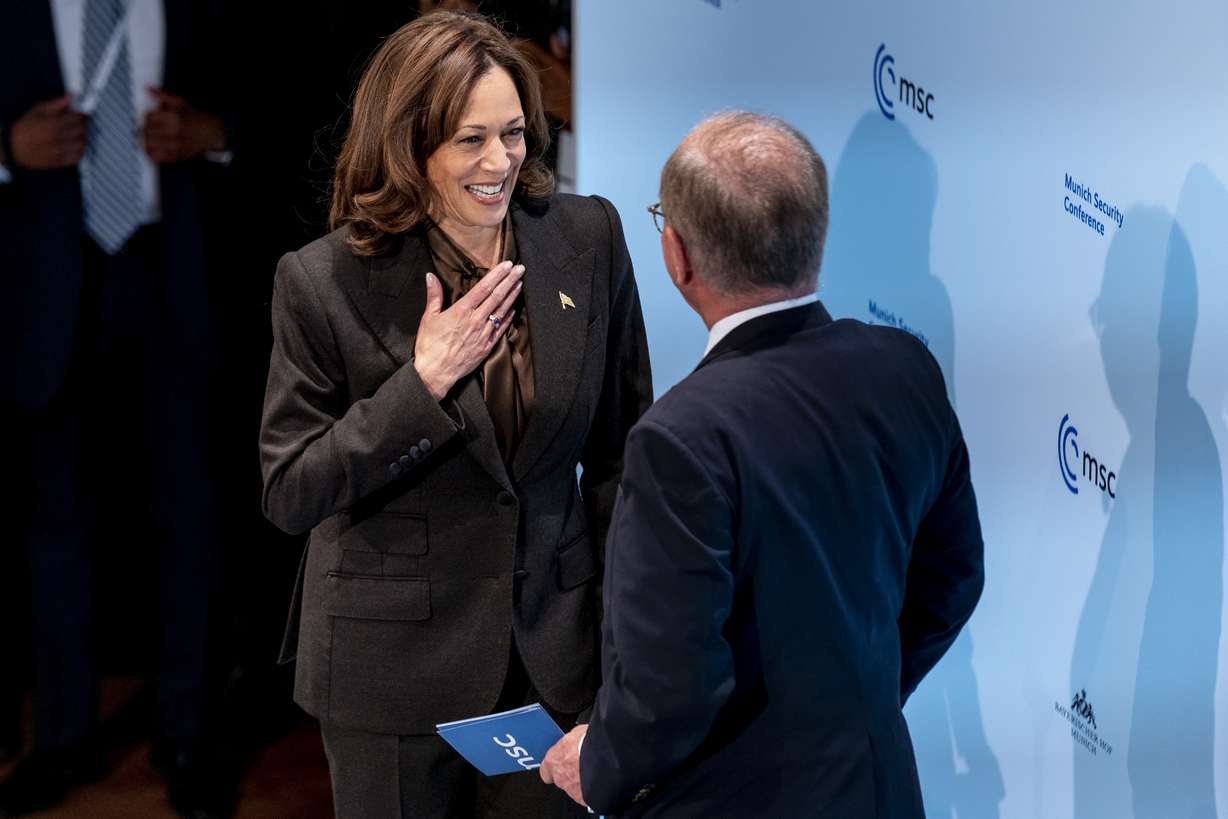 US Vice President Kamala Harris is welcomed on stage to speak by Munich Security Conference Chairman Wolfgang Ischinger, right, during the Munich Security Conference, Saturday, Feb. 19, 2022, in Munich.