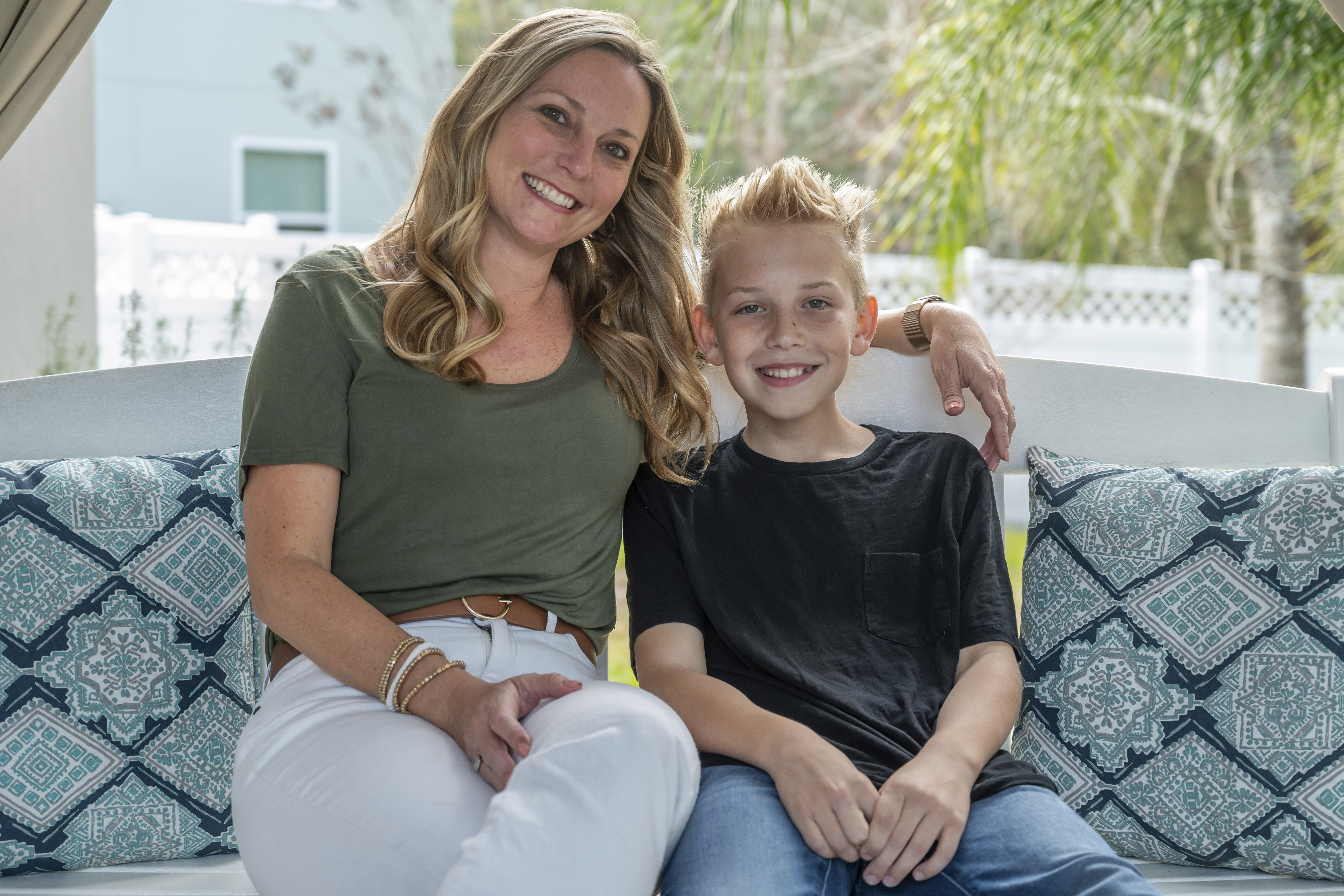 Holly Nover sits with her son, Colton Nover, 10, on a backyard swing at their home Wednesday, in St. Johns, Fla. They both have an issue with stuttering. Holly Nover is a speech pathologist active in the National Stuttering Association.