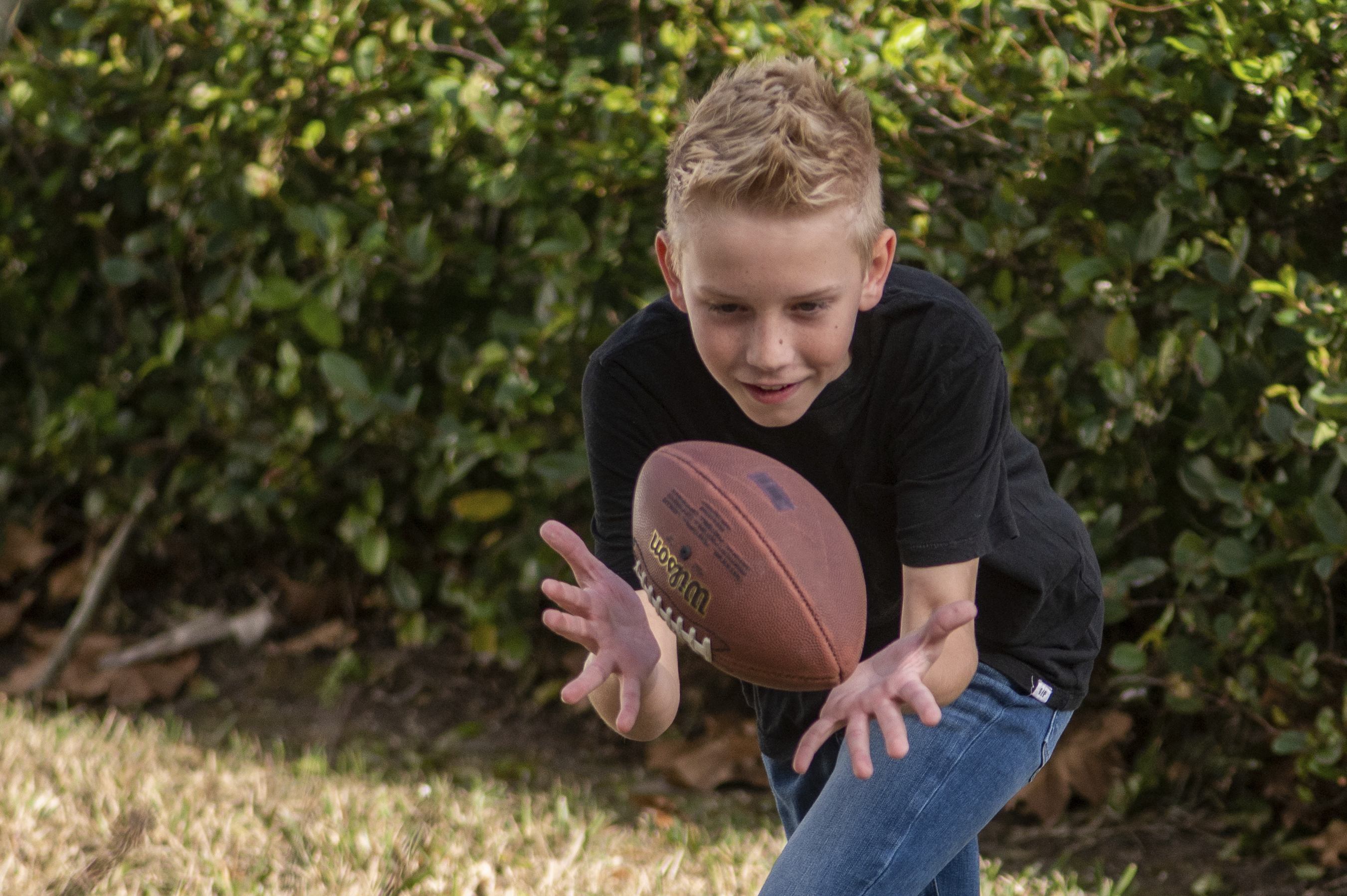 Colton Nover, 10, plays football with his younger brother on their front lawn Wednesday, in St. Johns, Fla. Colton has an issue with stuttering as does his mother.