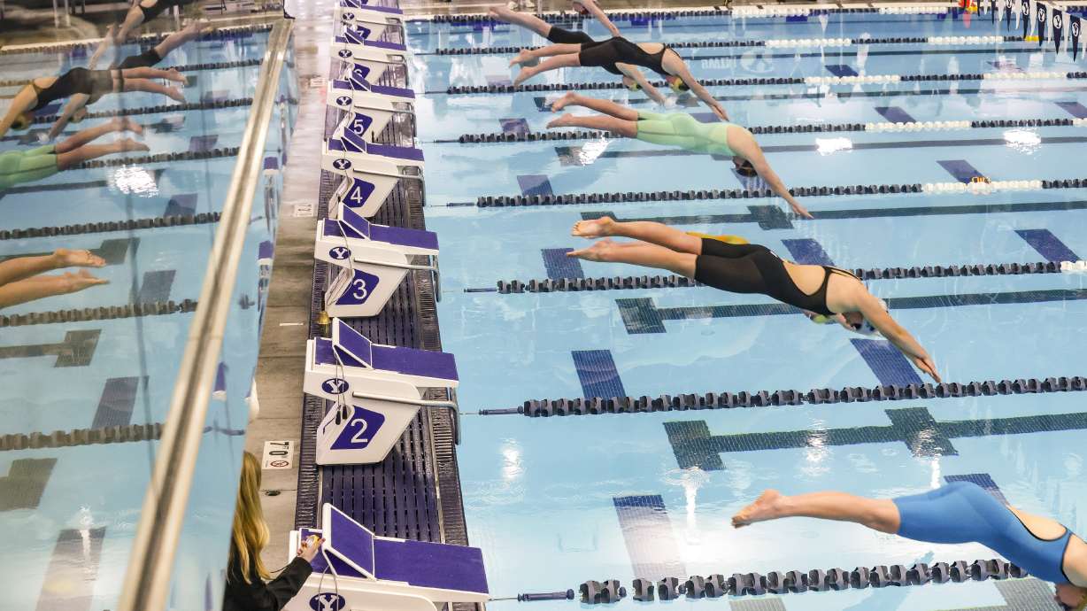Swimmers jumps into the pool during the women’s 500-yard freestyle at the 6A Swimming State Championships at Brigham Young University in Provo on Saturday, Feb. 19, 2022.