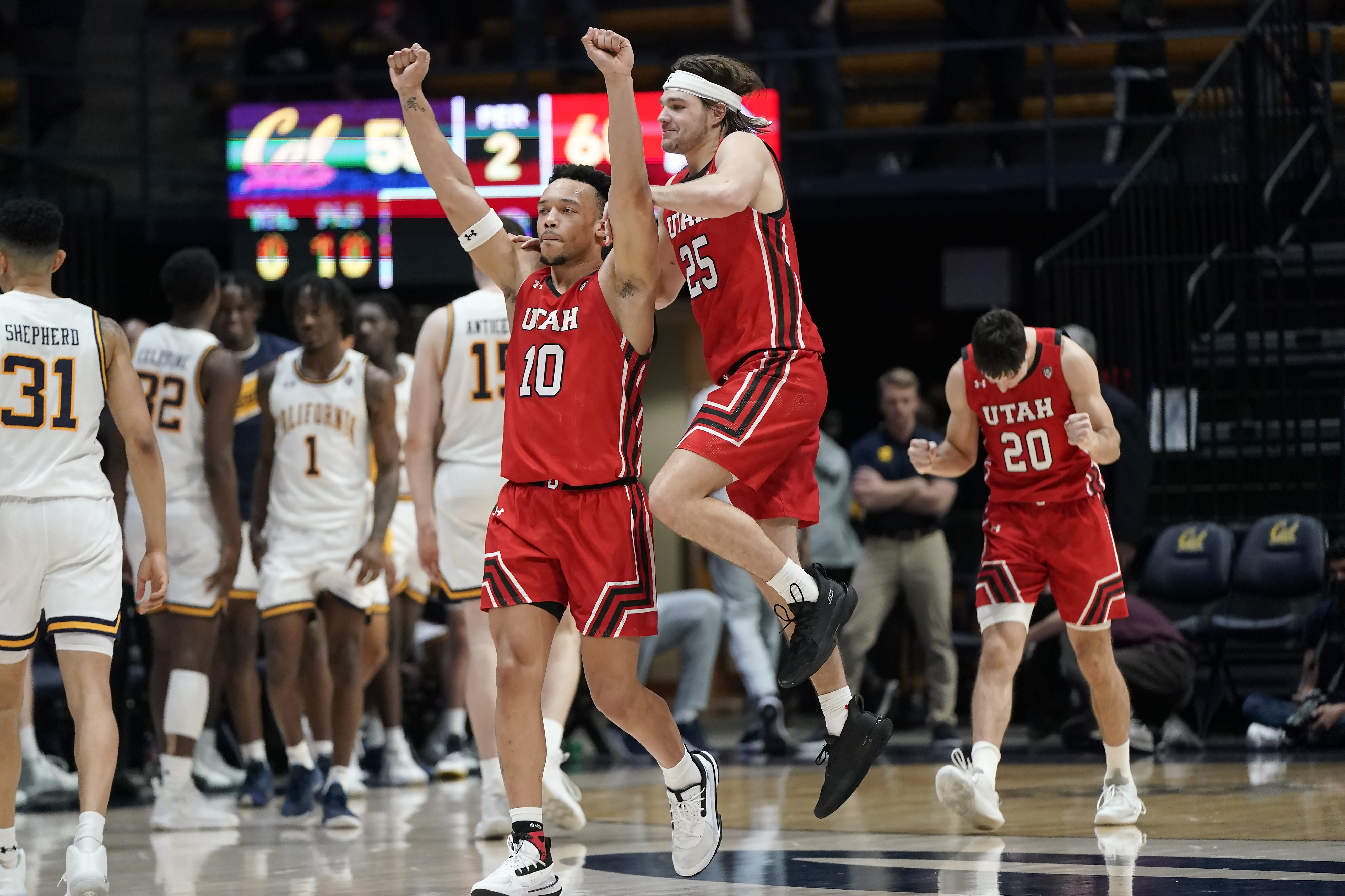 Utah guard Marco Anthony (10) celebrates with guard Rollie Worster (25) and guard Lazar Stefanovic (20) after Utah defeated California in an NCAA college basketball game in Berkeley, Calif., Saturday, Feb. 19, 2022. 