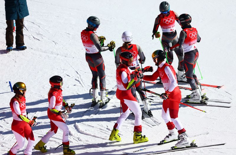2022 Beijing Olympics - Alpine Skiing - Mixed Team Parallel 1/2 Finals - National Alpine Skiing Centre, Yanqing district, Beijing, China - February 20, 2022.  Johannes Ewald Strolz of Austria is congratulated by his teammates Katharina Liensberger of Austria, Katharina Truppe of Austria and Stefan Brennsteiner of Austria after their team qualified for the next event.