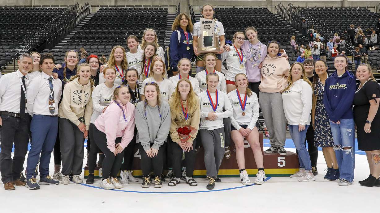 The Westalke girls wrestling team poses with the trophy after taking the 6A wrestling team championship at UCCU Arena in Orem, Utah on Saturday, Feb. 19, 2022.