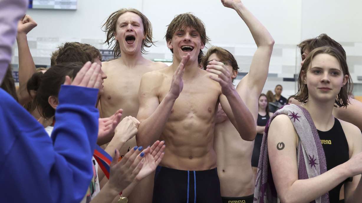 Olympus High men cheer after hearing the announcement that they finished in first place at the 5A state swimming championships at BYU in Provo on Saturday, Feb. 19, 2022.
