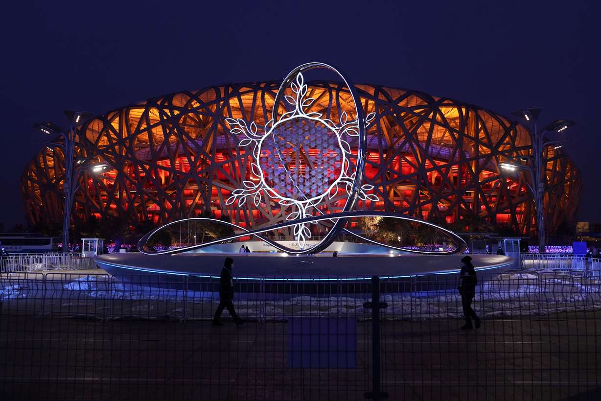 The Olympic flame burning in the center of the snowflake-shaped cauldron is on display near the National Stadium at the 2022 Winter Olympics, Thursday, Feb. 17, in Beijing.