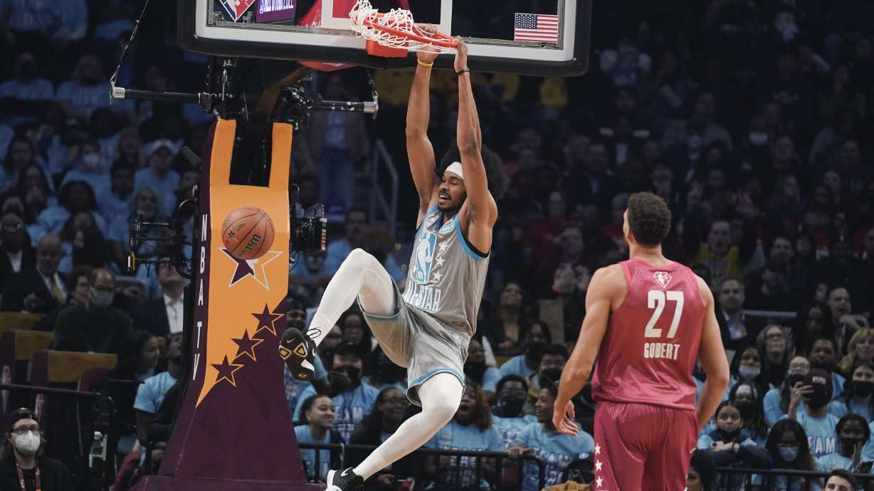 Cleveland's Jarrett Allen, left, finishes off a dunk in front of Utah Jazz center Rudy Gobert during the first half of the NBA All-Star basketball game, Sunday, Feb. 20, 2022, in Cleveland.