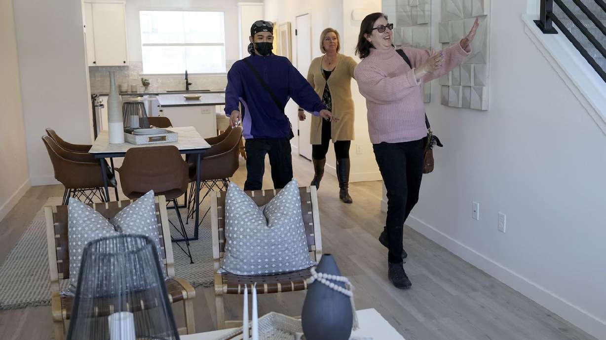 Prospective buyer Aaron Khan, left, Brighton Homes
sales agent Julie Blum and Helene Kepas-Brown, Coldwell Banker real
estate agent, walk through a two bedroom, two-and-a-half bathroom
model unit town house at Park Lofts at City Center, by Brighton
Homes, in North Salt Lake on Friday.