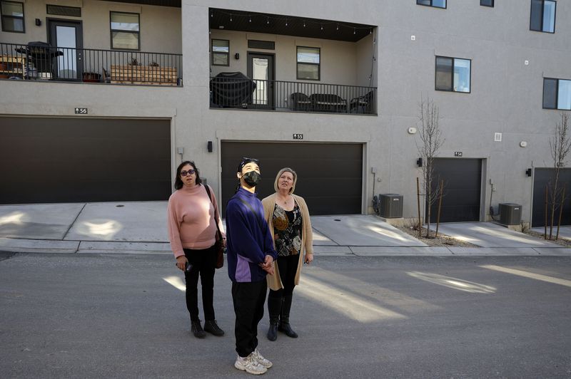 Coldwell Banker real estate agent Helene Kepas-Brown,
left, prospective buyer Aaron Khan and Brighton Homes sales agent
Julie Blum look at different town houses at Park Lofts at City
Center, by Brighton Homes, in North Salt Lake on Friday.