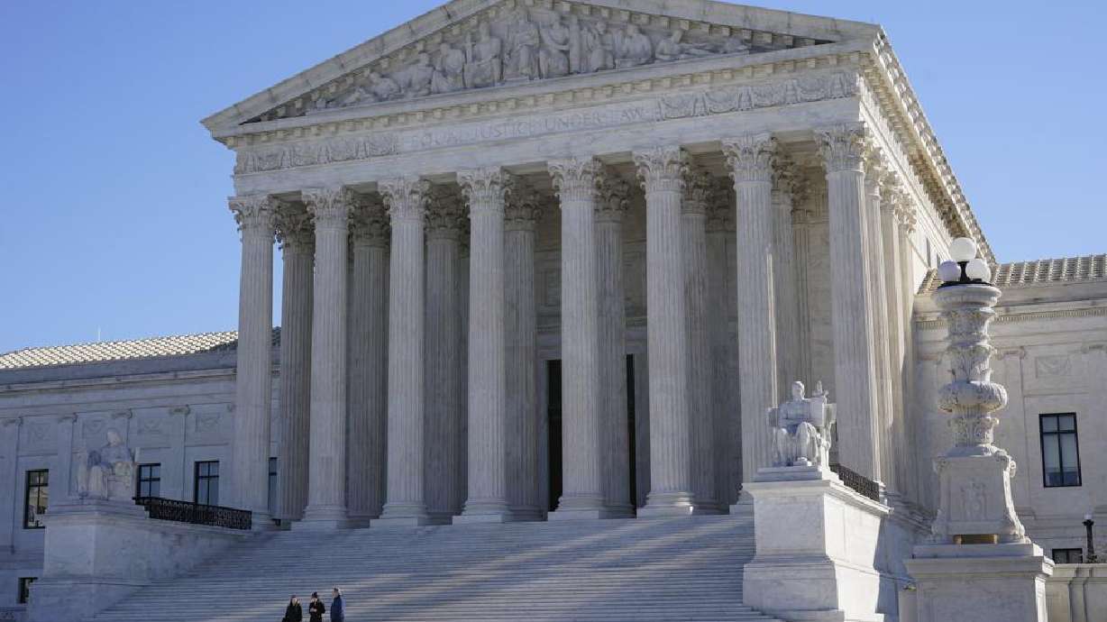 Visitors walk outside the Supreme Court building on Capitol Hill in Washington on Monday. The Supreme Court has agreed to hear a new case involving religion and the rights of LGBTQ people.