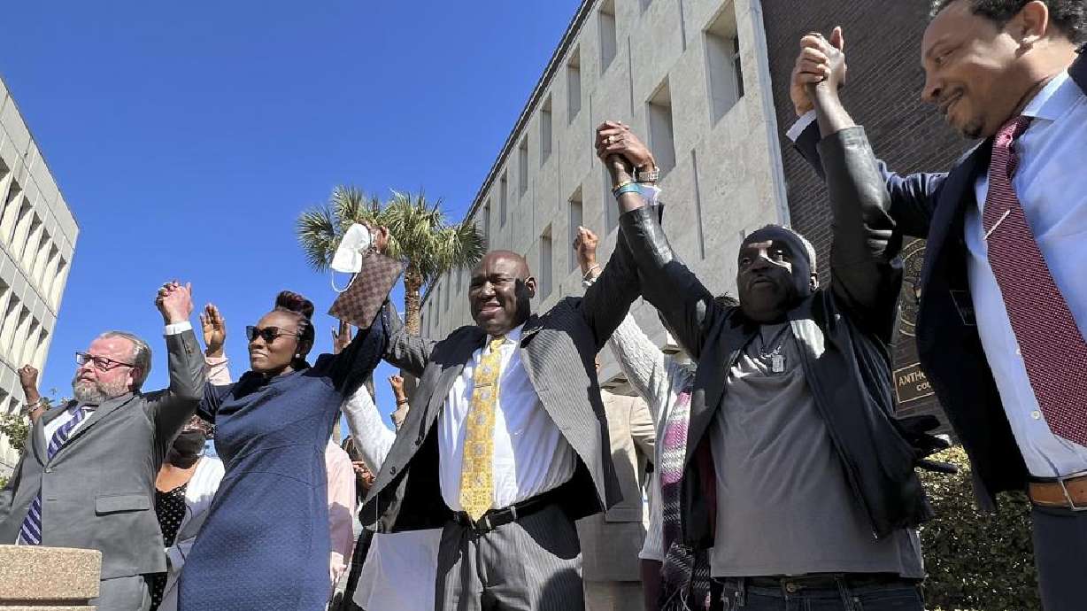 The family and attorneys of the Ahmaud Aubery raise their arms in victory after all three men were found guilty of hate crimes at the federal courthouse in Brunswick, Ga., on Tuesday, Feb. 22. The three men convicted of murder in Arbery’s fatal shooting have been found guilty of federal hate crimes.