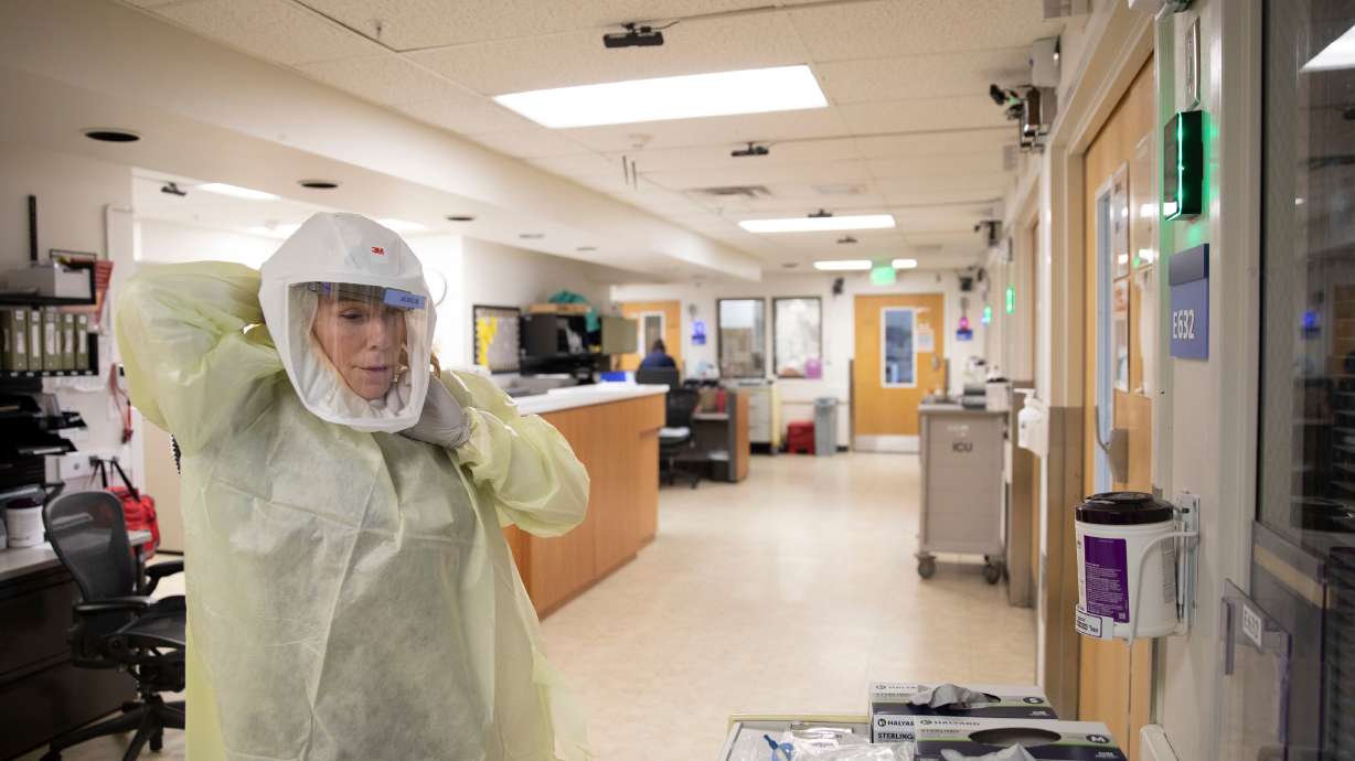 Medical personnel work at LDS Hospital’s COVID-19 unit in Salt Lake City on Feb. 3. New cases are decreasing, but COVID-19 is still out there and the likelihood of contracting it depends on individual risk and local transmission levels, Utah doctors said Tuesday, adding that vaccines are still key.