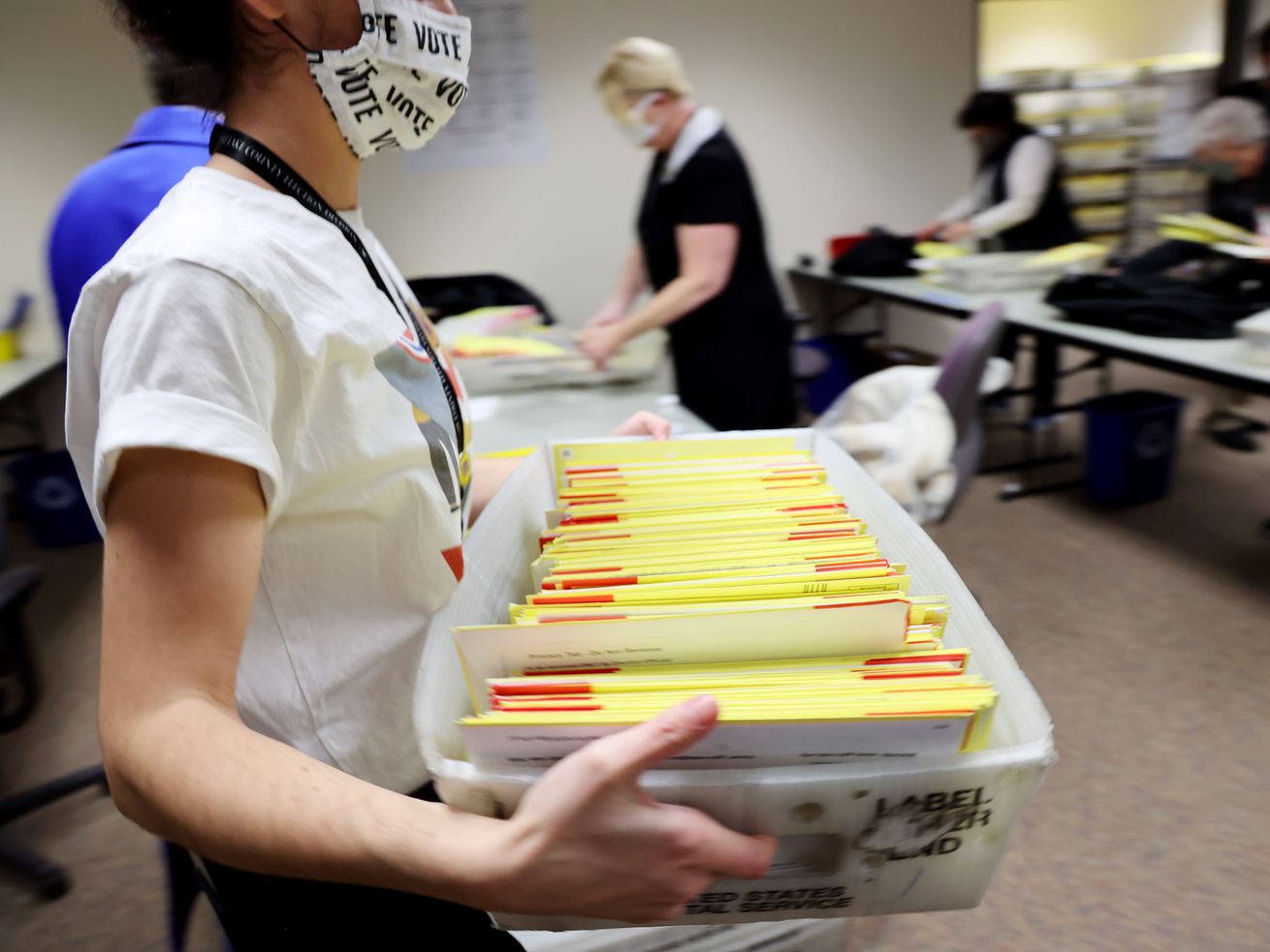 A worker carries a bin of ballots to a rolling cart as
election workers process ballots at the Salt Lake County Clerk’s
Office in Salt Lake City on Nov. 3, 2020. Lawmakers have proposed a variety of changes to improve elections in Utah, two of which have received broad support — including from the state's highest election official.