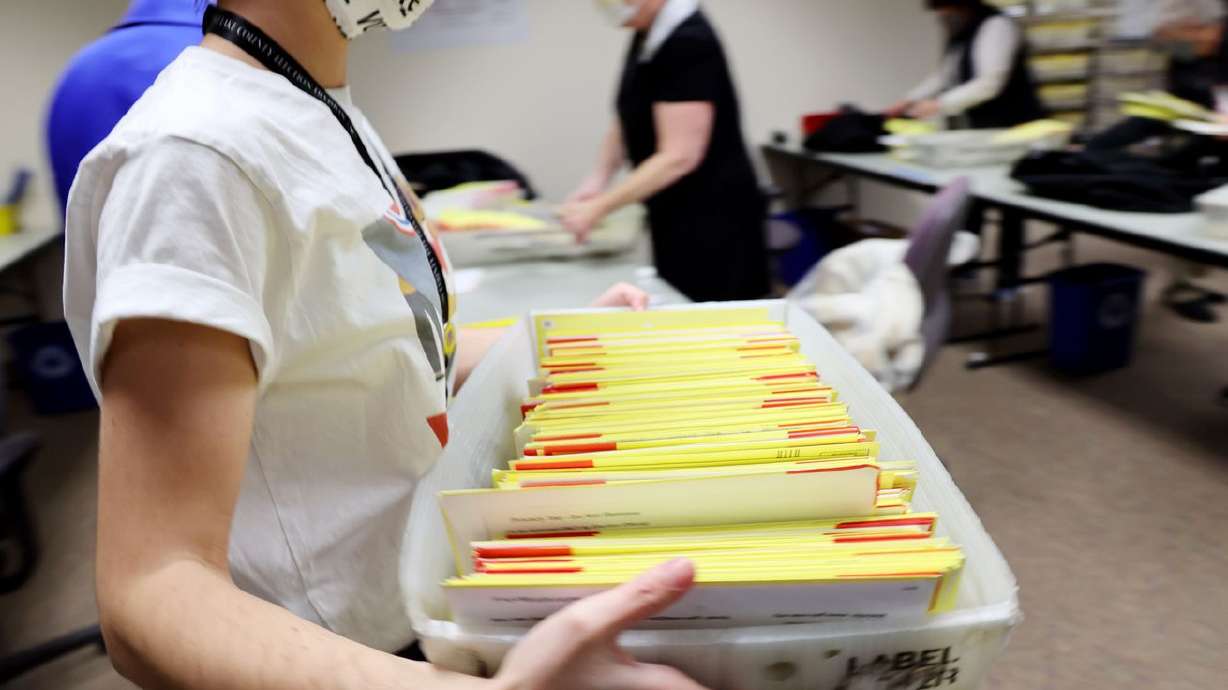 A worker carries a bin of ballots to a rolling cart as
election workers process ballots at the Salt Lake County Clerk’s
Office in Salt Lake City on Nov. 3, 2020. Lawmakers have proposed a variety of changes to improve elections in Utah, two of which have received broad support — including from the state's highest election official.