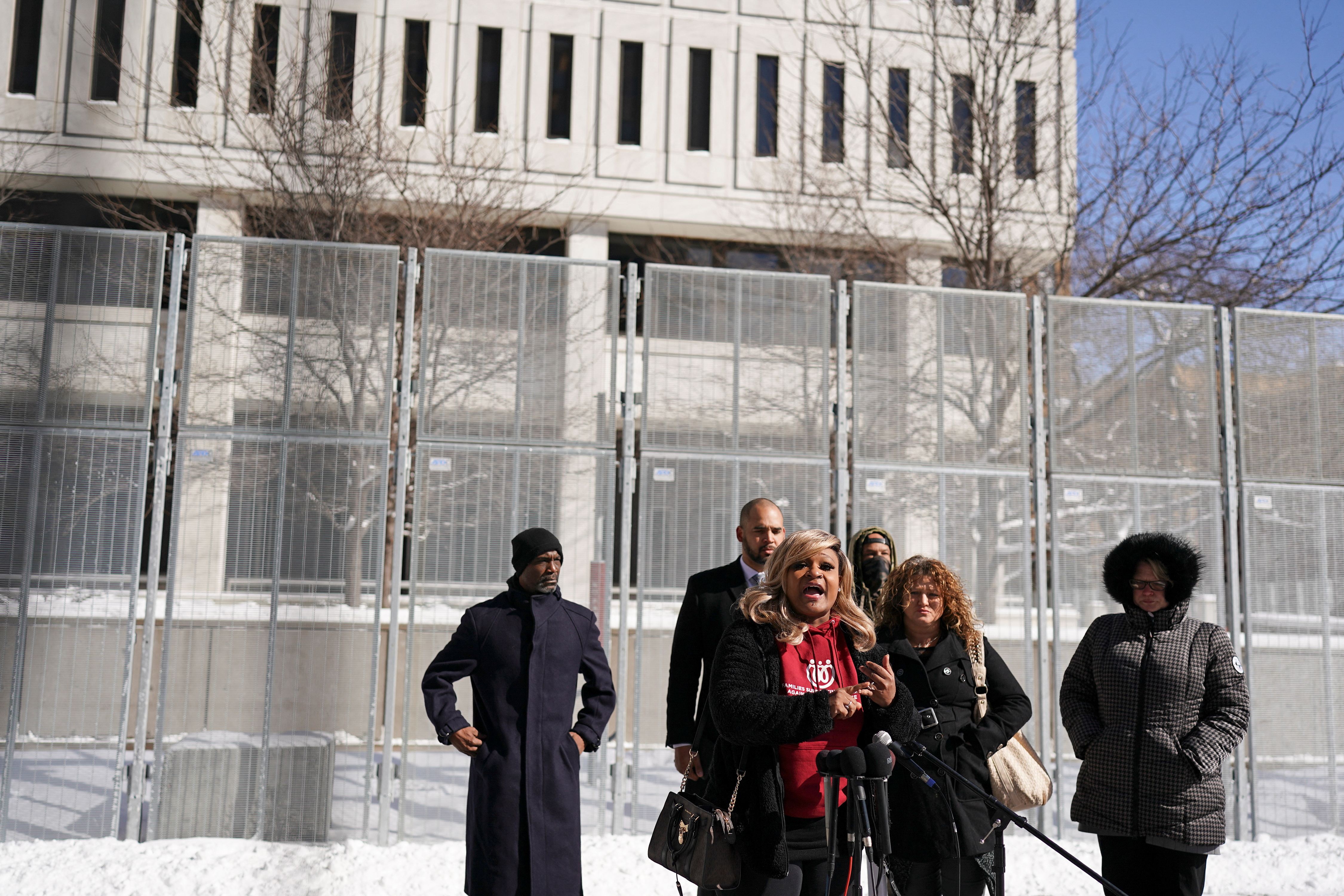 Community advocates and Courtney Ross, the girlfriend of George Floyd speak during a news conference during the trial of three former Minneapolis police officers on charges of violating George Floyd's civil rights in a deadly May 2020 arrest, outside court in St. Paul, Minnesota, Wednesday.