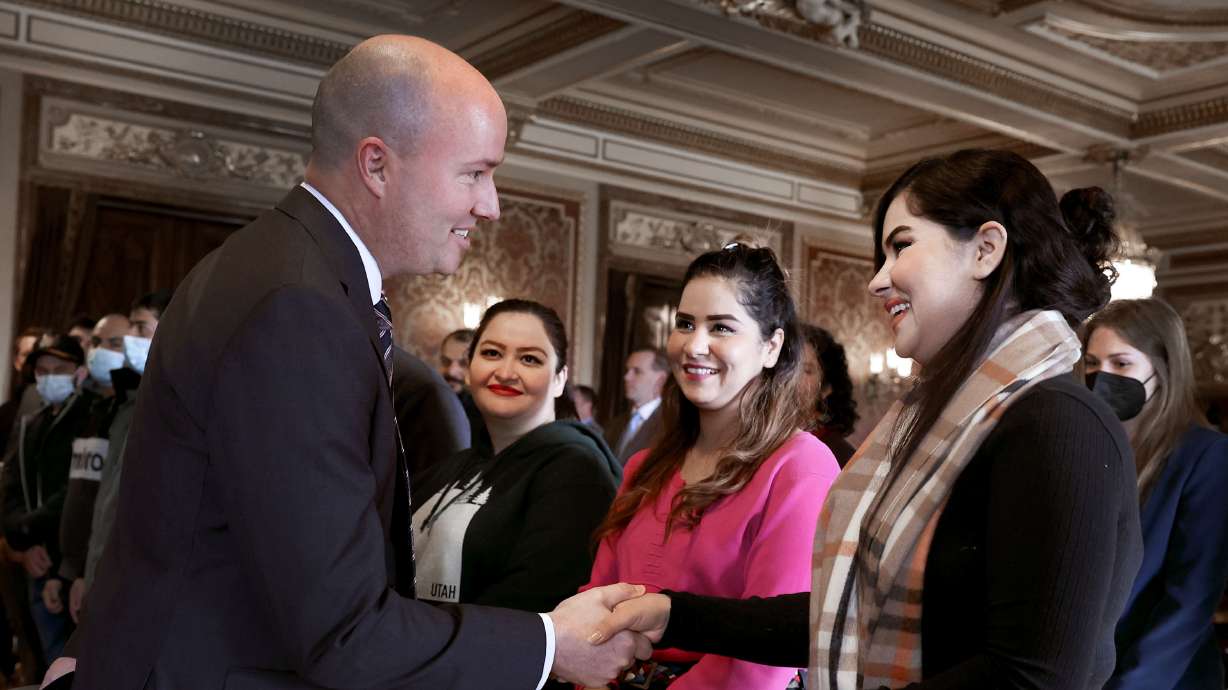 Gov. Spencer J. Cox, left, greets Kamila Emami, right, Khatima Emami and Saida Emami at the Capitol in Salt Lake City on Wednesday. He announced that the state is moving into the second phase of helping more than 900 Afghan refugees in Utah with education, training and employment.