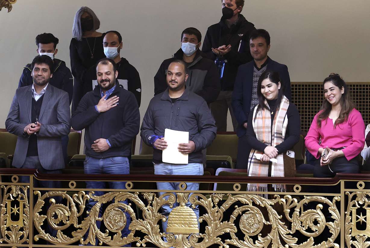 Recently arrived Afghans accept applause and a standing ovation from members of the House of Representatives during the kickoff for Afghan Day on the Hill at the Capitol in Salt Lake City on Wednesday.