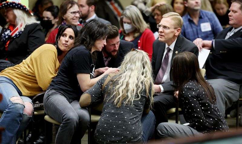 Former Rep. Steve Christiansen, right, talks with a
group of people before a hearing on HB371 in the House Government
Operations Standing Committee at the Capitol in Salt Lake City on
Wednesday.