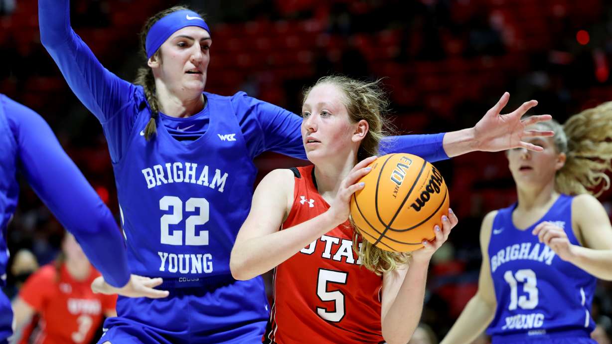 BYU Cougars center Sara Hamson (22) defends Utah Utes guard Gianna Kneepkens (5) as Utah and BYU women compete in a basketball game at the Huntsman Center in Salt Lake City on Dec. 4, 2021. BYU won 85-80.