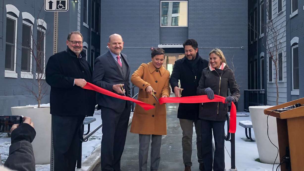 Salt Lake City Mayor Erin Mendenhall, center, cuts a ribbon to celebrate the reopening of the Jackson Apartments in Salt Lake City, Thursday. Mendenhall is standing next to (left to right): Private Activity Bond Authority chairman John Crandall, Utah Housing Corporation President and CEO David Damschen, The Hampstead Companies president Greg Gossard and Salt Lake City Councilwoman Ana Valdemoros.