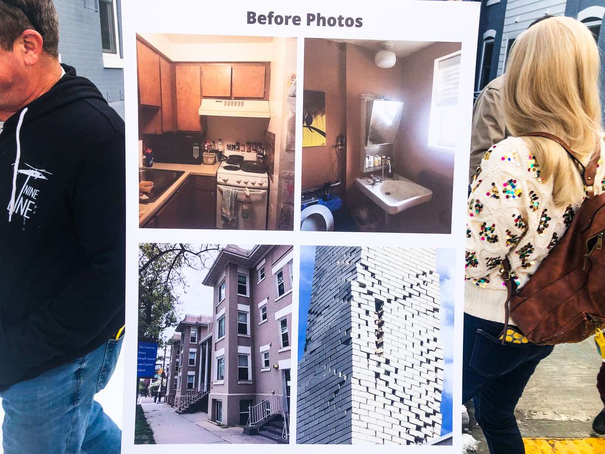 Photos of the Jackson Apartments exterior and interior on display during a reopening event Thursday. The photos were taken in 2020 prior to an 18-month renovation of the complex.