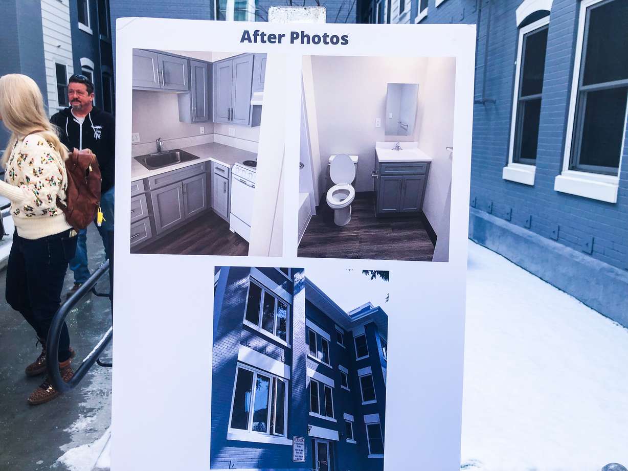 Photos of the Jackson Apartments exterior and interior on display during a reopening event Thursday. The photos were taken after an 18-month renovation of the complex.