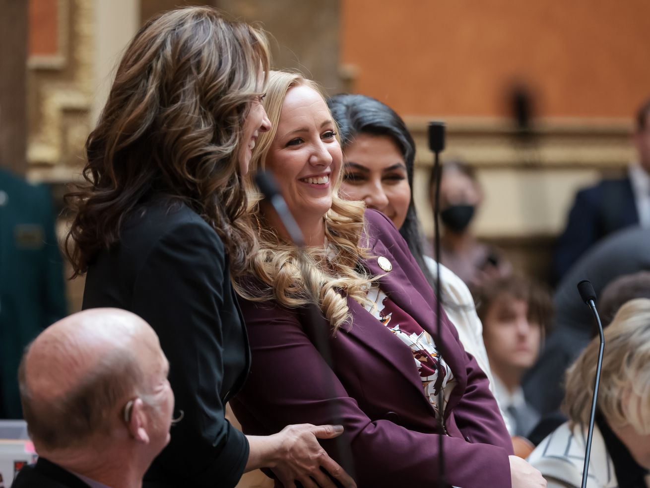 Rep. Candice Pierucci, R-Herriman, center, Utah first
lady Abby Cox, left, and Luna Banuri, executive director of the
Utah Muslim Civic League, back right, stand together as Pierucci
presents HCR16, which recognizes student athletes’ rights to
religious freedom and modesty, in the House chamber at the Capitol
in Salt Lake City on Thursday.
