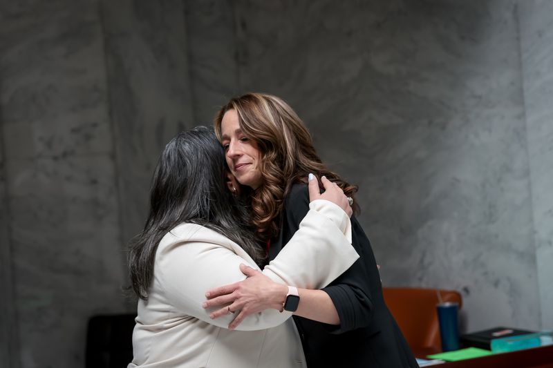 Luna Banuri, executive director of the Utah Muslim
Civic League, left, hugs Utah first lady Abby Cox after they each
came to support HCR16, which recognizes student athletes’ rights to
religious freedom and modesty, at the Capitol in Salt Lake City on
Thursday.