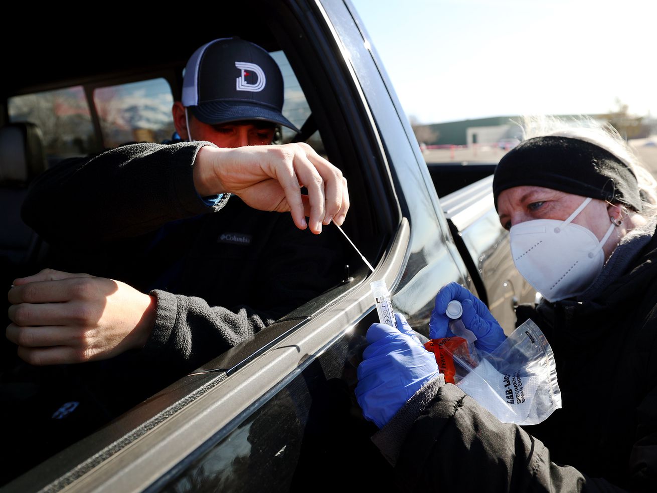 Registered nurse Paula Moffitt collects a COVID-19 nasal swab from Nathan Graham at the University of Utah in Salt
Lake City on Jan. 31. When it comes to handling any future COVID-19 surges in Utah, Gov. Spencer Cox’s new “steady state” plan will likely look a lot like the old plan.