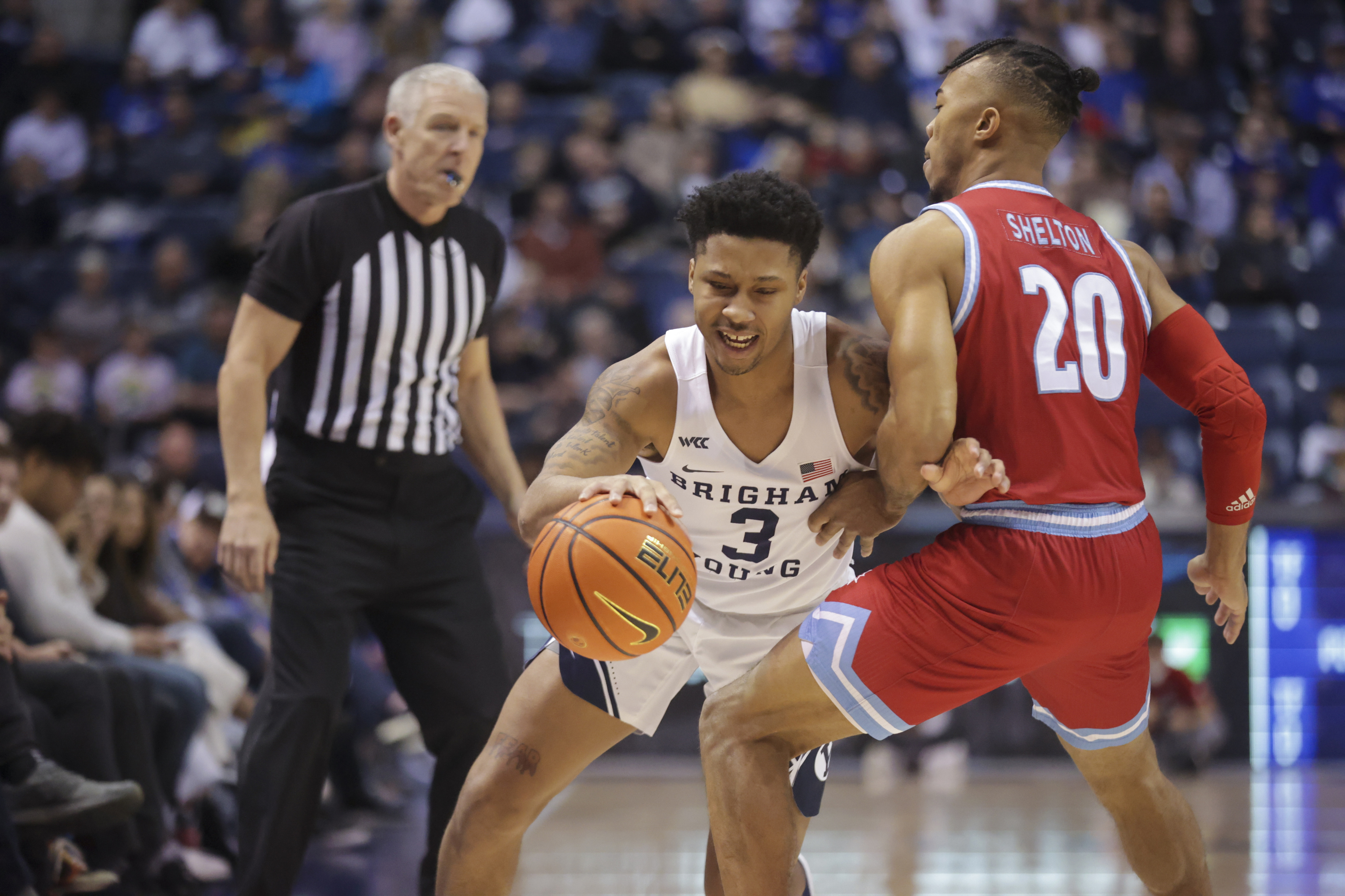 Loyola Marymount guard Cam Shelton (20) defends Brigham Young guard Te'Jon Lucas (3) as Brigham Young Cougars plays Loyola Marymount Lions in an NCAA basketball game at Marriott Center in Provo, Feb. 24, 2022.