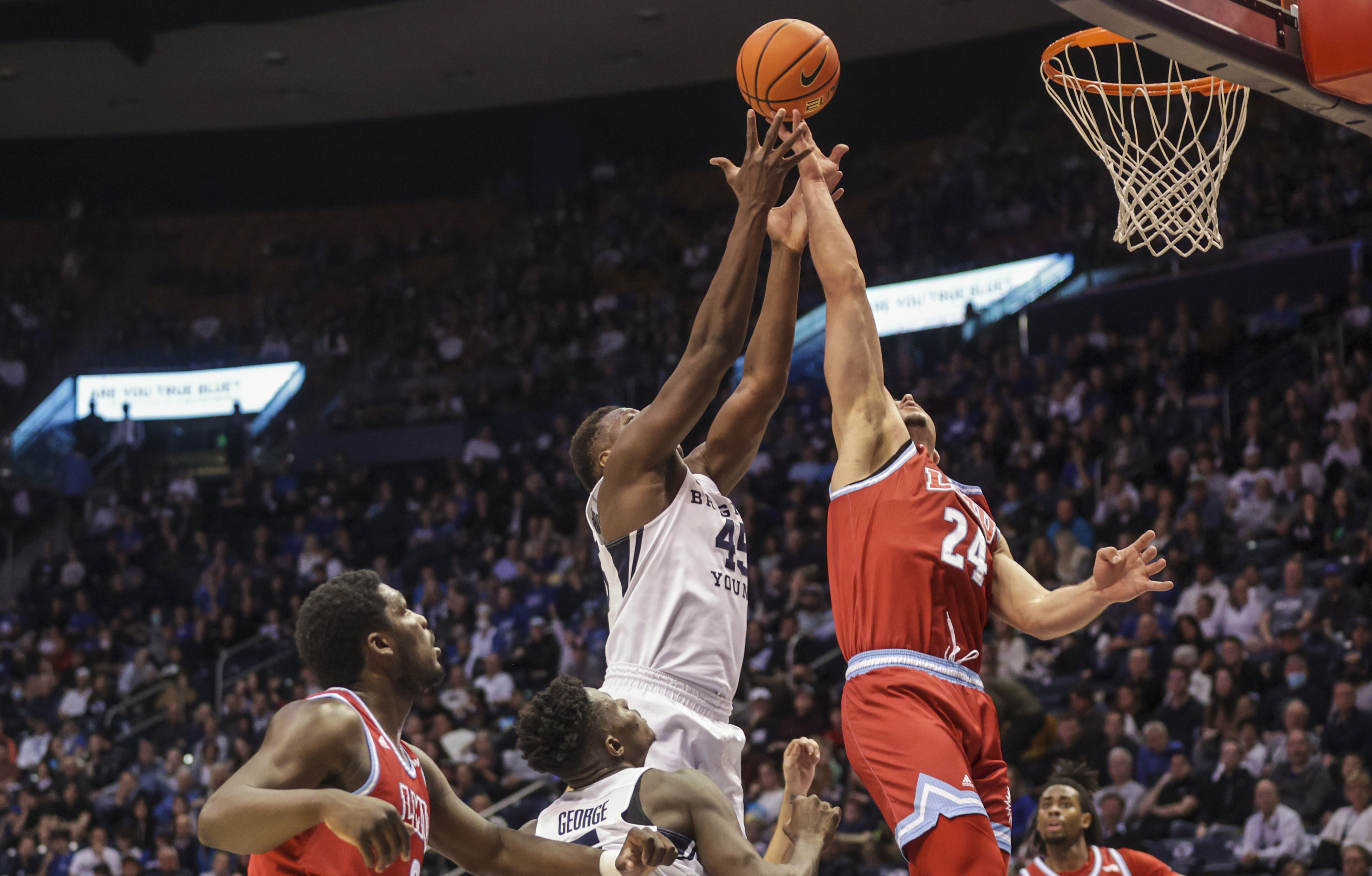 Loyola Marymount Lions forward Alex Merkviladze (24) grabs a rebound as Brigham Young Cougars plays Loyola Marymount Lions in an NCAA basketball game at Marriott Center in Provo on Thursday, Feb. 24, 2022.