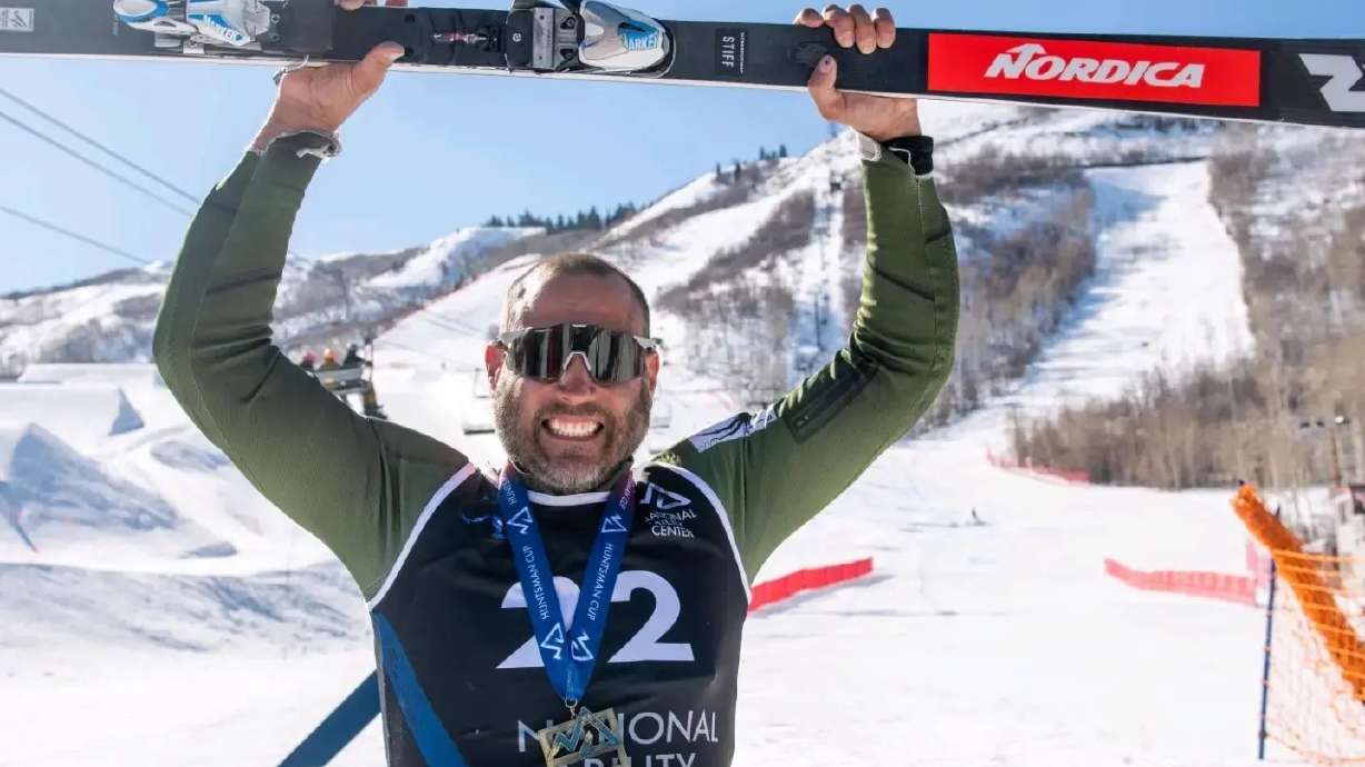 Matthew Brewer raises his ski after receiving a gold medal at the Huntsman Games in Park City on Feb. 12. After years of difficult struggles, he will soon be competing in Beijing as a Paralympic athlete for Team USA.