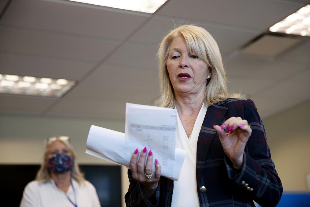 Mesa County Clerk Tina Peters reads an update on the election in Grand Junction, Colo., on June 30, 2020. Election officials preparing for this year’s midterm elections have yet another concern to add to an already long list of threats.