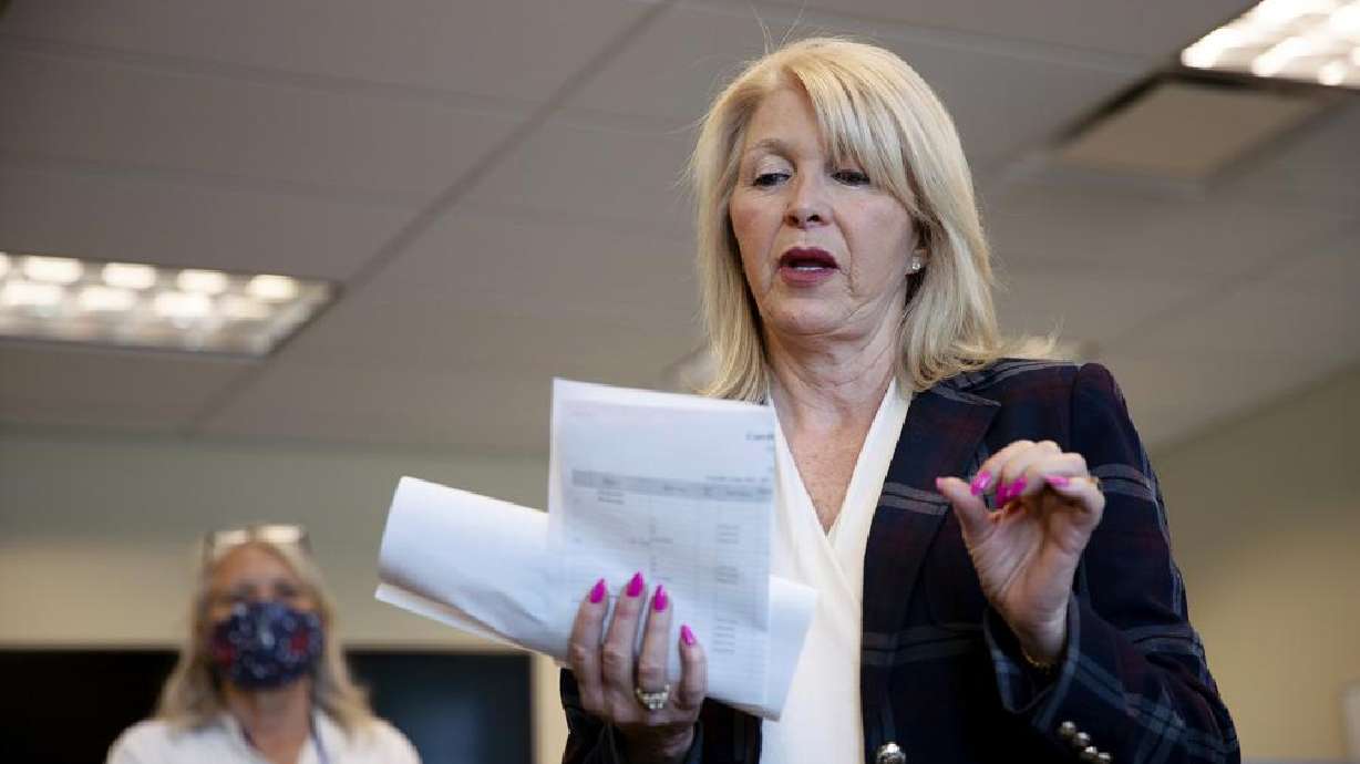 Mesa County Clerk Tina Peters reads an update on the election in Grand Junction, Colo., on June 30, 2020. Election officials preparing for this year’s midterm elections have yet another concern to add to an already long list of threats.