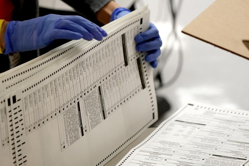 Maricopa County elections officials count ballots at the Maricopa County Recorder's Office in Phoenix, Nov. 4, 2020. Election officials preparing for this year’s midterm elections have yet another concern to add to an already long list of threats that includes the potential for equipment failures, ransomware or a cyberattack waged by a hostile foreign government.