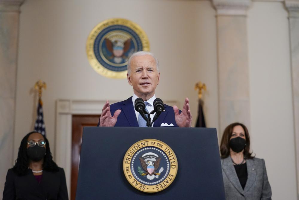 President Joe Biden speaks as he announces Judge Ketanji Brown Jackson, left, as his nominee to the Supreme Court in the Cross Hall of the White House, Friday, in Washington. Vice President Kamala Harris listens at right.