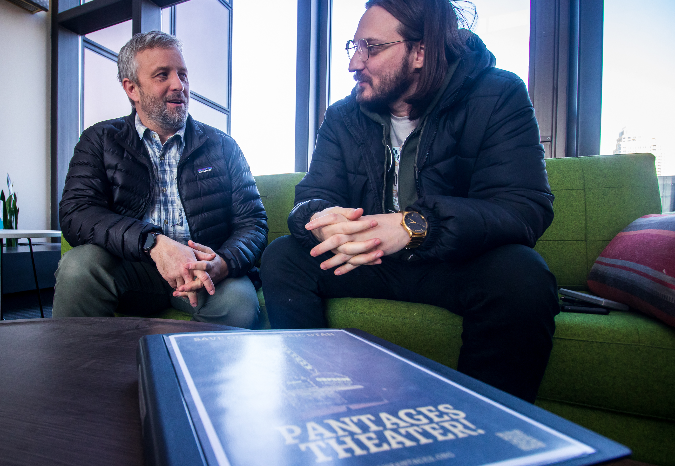 Casey McDonough, left, and Michael Valentine, right, co-founders of the Friends of the Utah Pantages Theater, share contents from a binder of public records they've collected regarding Utah Pantages Theater. during an interview with KSL.com on Feb. 8. The group filed a lawsuit against Salt Lake City over the future of the Utah Pantages Theater on Thursday.