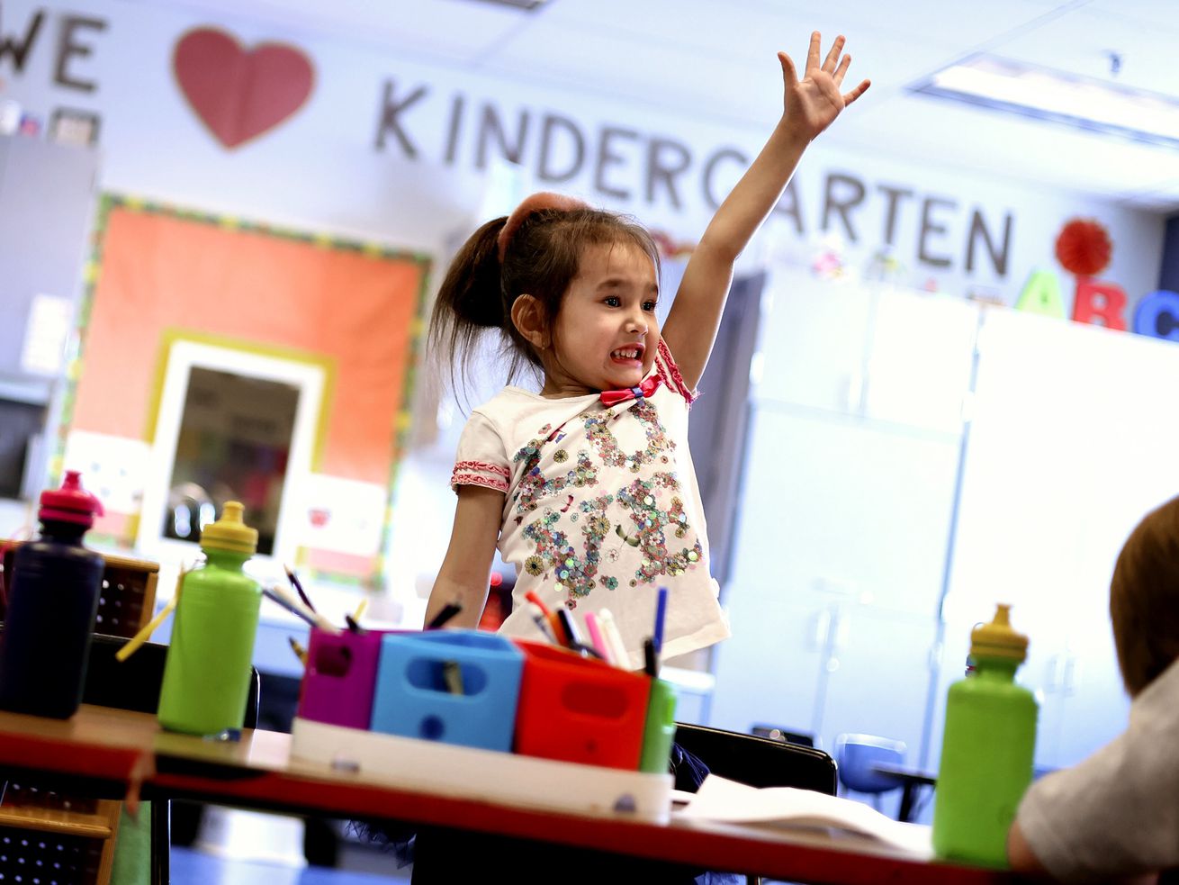 Kindergartner Kira Bubeeva raises her hand during class at Woodrow Wilson Elementary School in Salt Lake City on Friday. Legislators are debating the latest version of HB193, which seeks to provide more state funding to increase the number of Utah public schools that offer full-day kindergarten.
