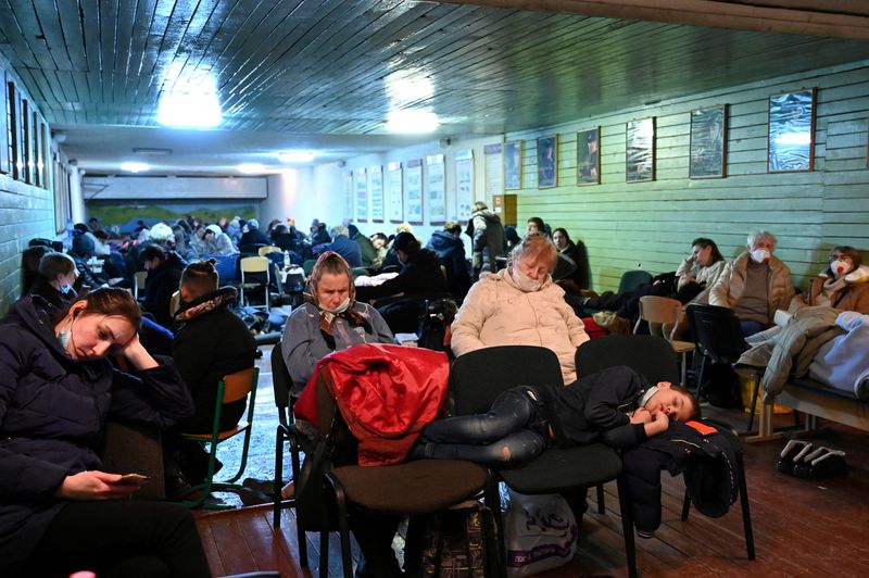 People gather in an air raid shelter in Kyiv, Ukraine, on Friday.