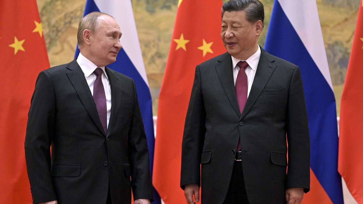 Chinese President Xi Jinping, right, and Russian President Vladimir Putin talk to each other during their meeting in Beijing, Feb. 4. China is the only friend that might help Russia blunt the impact of economic sanctions over its invasion of Ukraine.