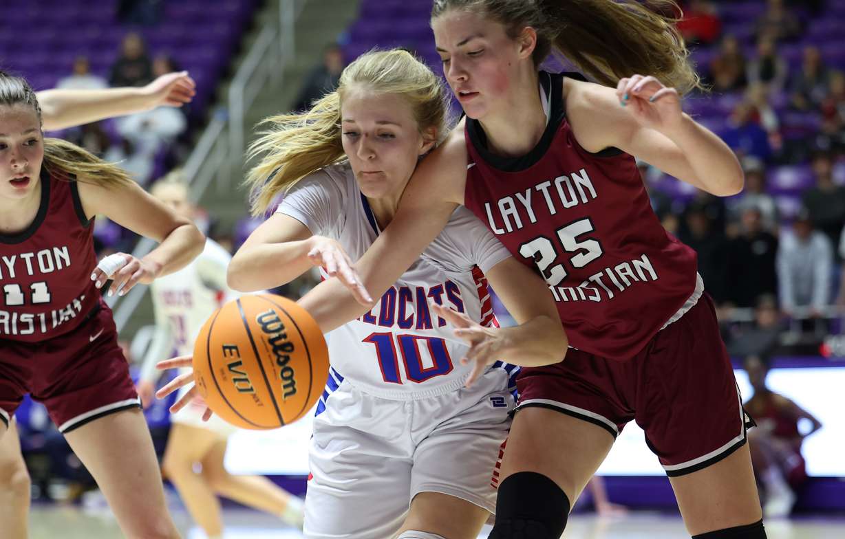 Richfield’s Sydney Knutson and Layton Christian’s Mia Jones battle for the ball as they play in 3A girls basketball semifinal action at Weber State University in Ogden on Friday, Feb. 25, 2022. Richfield won 43-39.