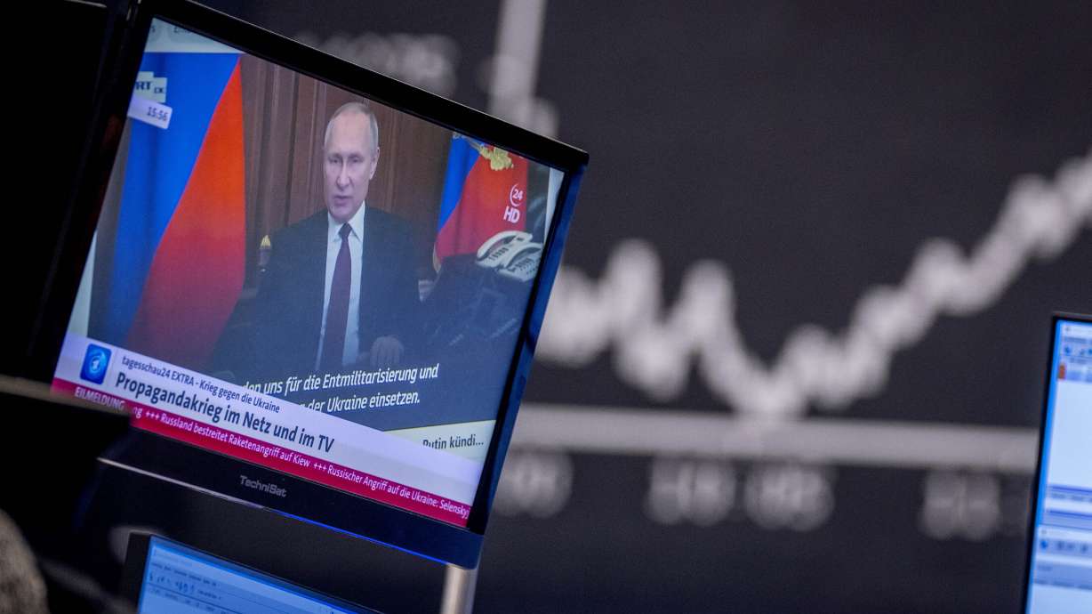 Russia President Vladimir Putin appears on a television screen at the stock market in Frankfurt, Germany, on Friday. Russia is revving up its sophisticated propaganda machine as its military advances in neighboring Ukraine.